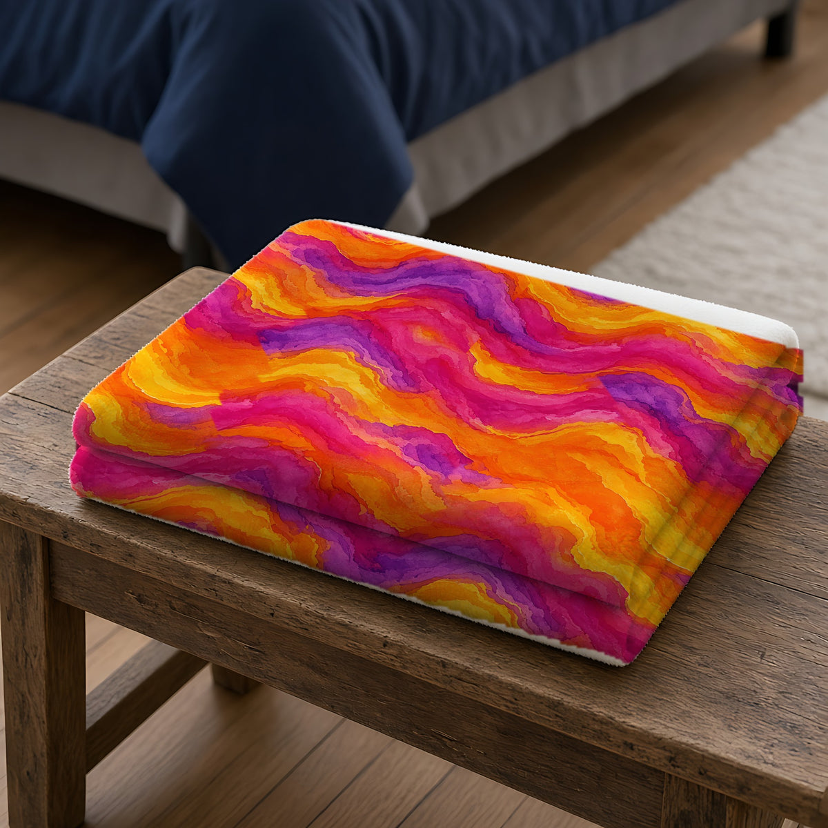 Ombre Wash Bands Sherpa Fleece Blanket folded on a wooden bench