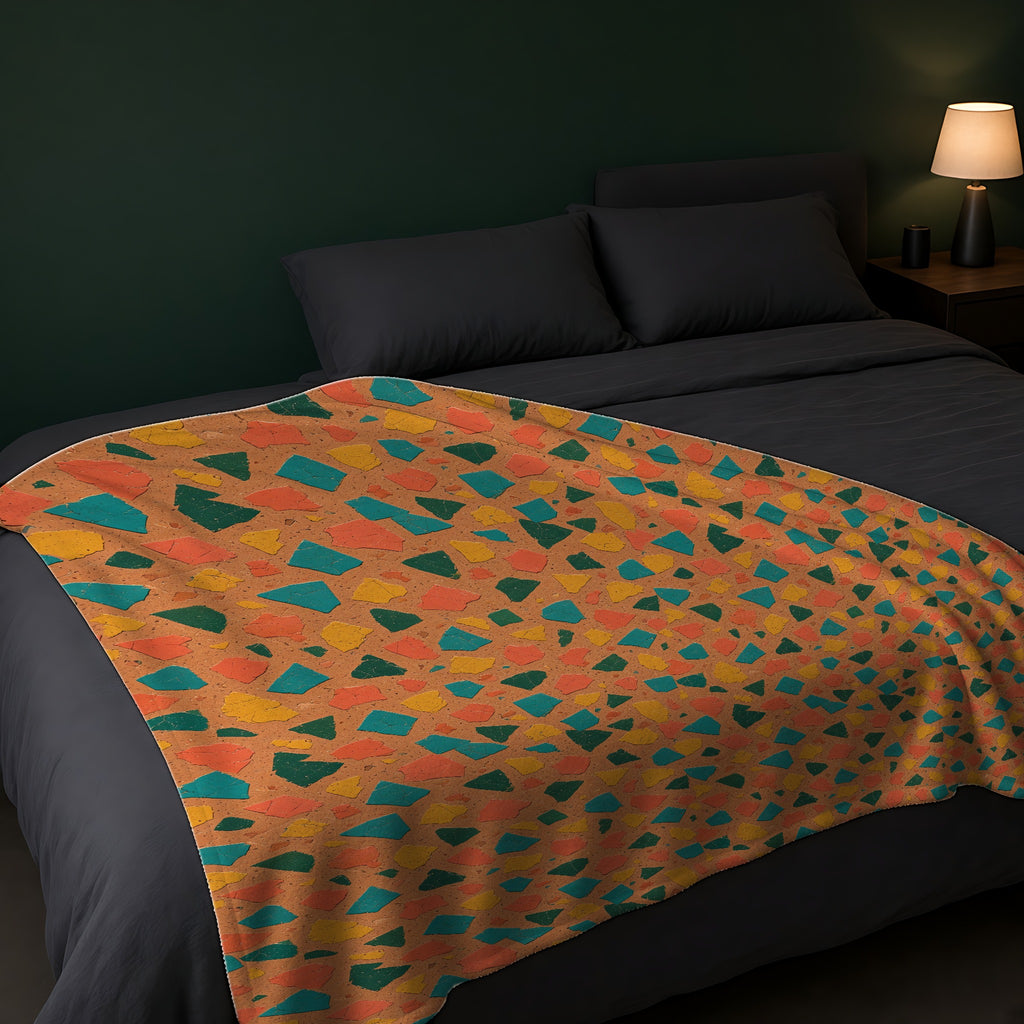 Shattered Tile Shards Sherpa Fleece Blanket across the foot of a dark bed