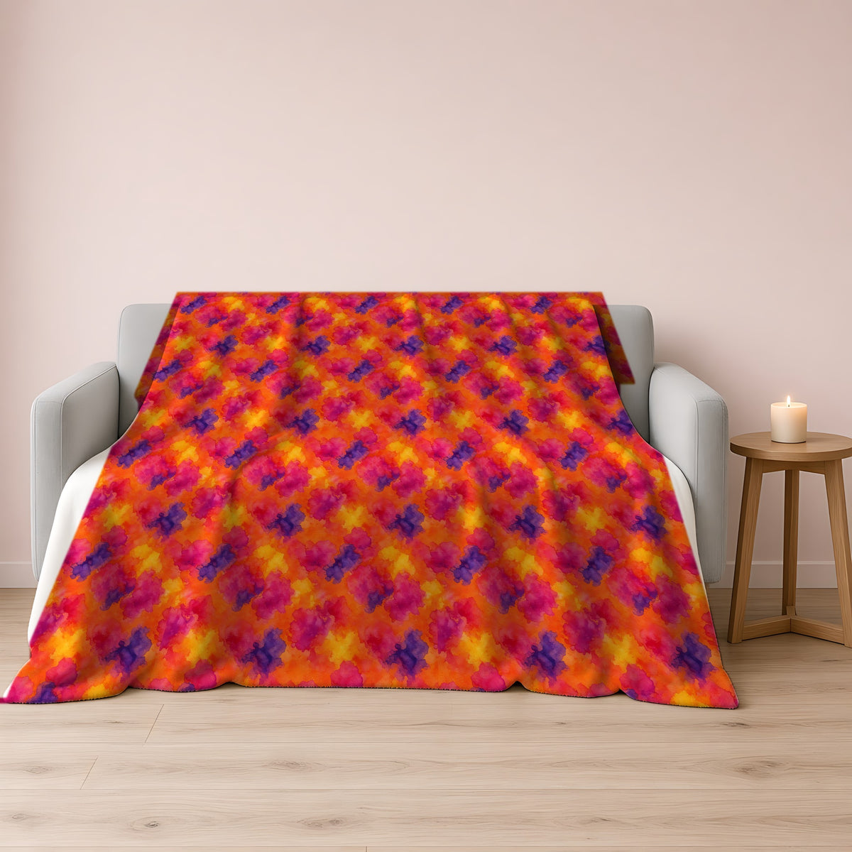 Sunset Bloom Bleeds Sherpa Fleece Blanket draped over a grey sofa