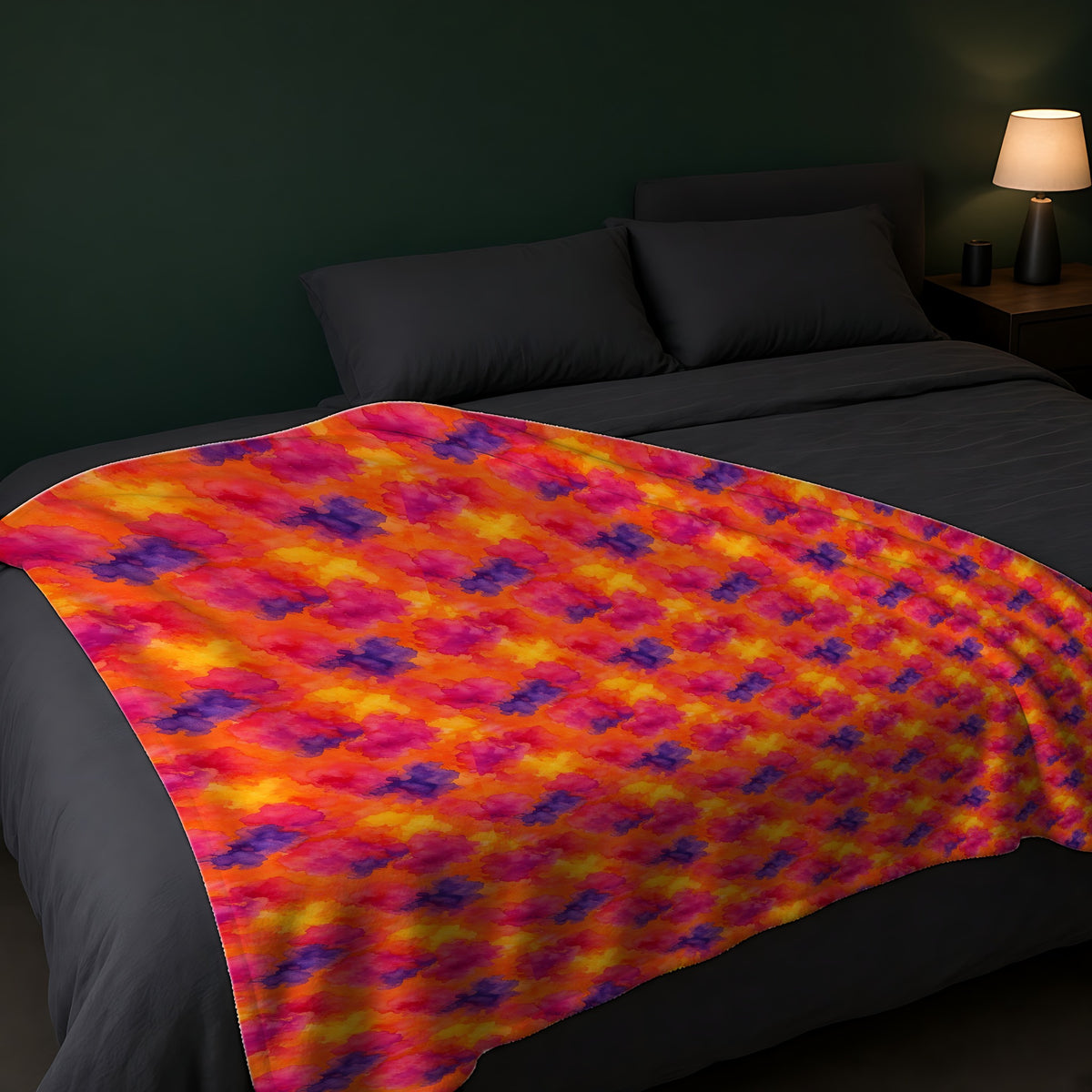Sunset Bloom Bleeds Sherpa Fleece Blanket across the foot of a dark bed