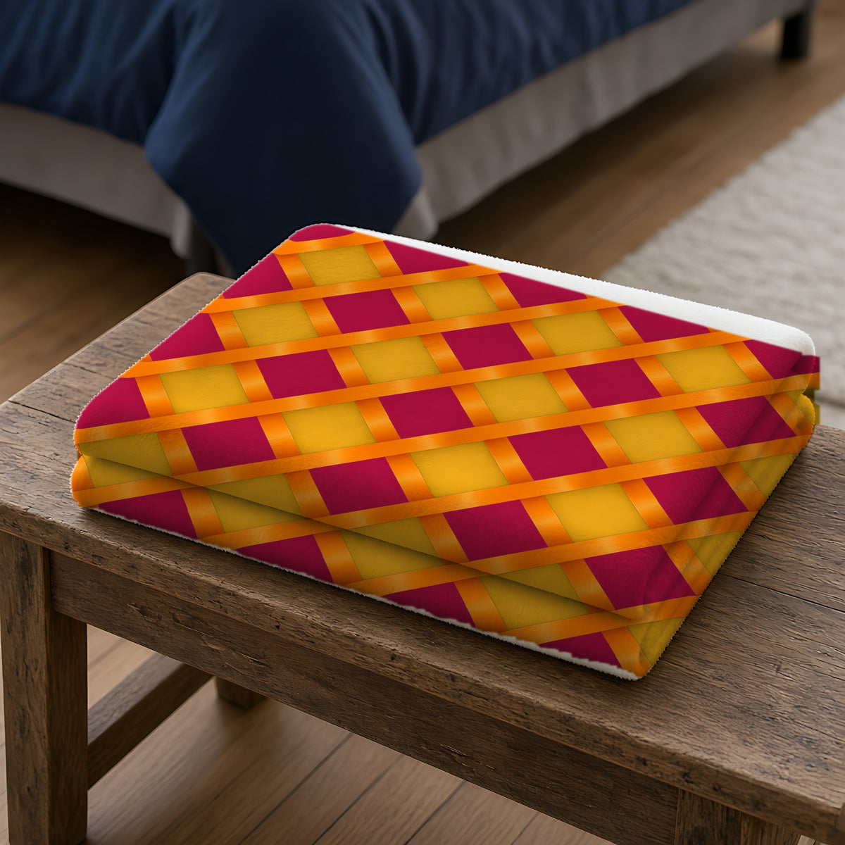 Broad Gold Diamond Trellis Sherpa Fleece Blanket folded on a wooden bench