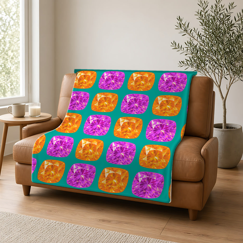 Giant Cut Gem Grid Sherpa Fleece Blanket draped over a caramel leather sofa