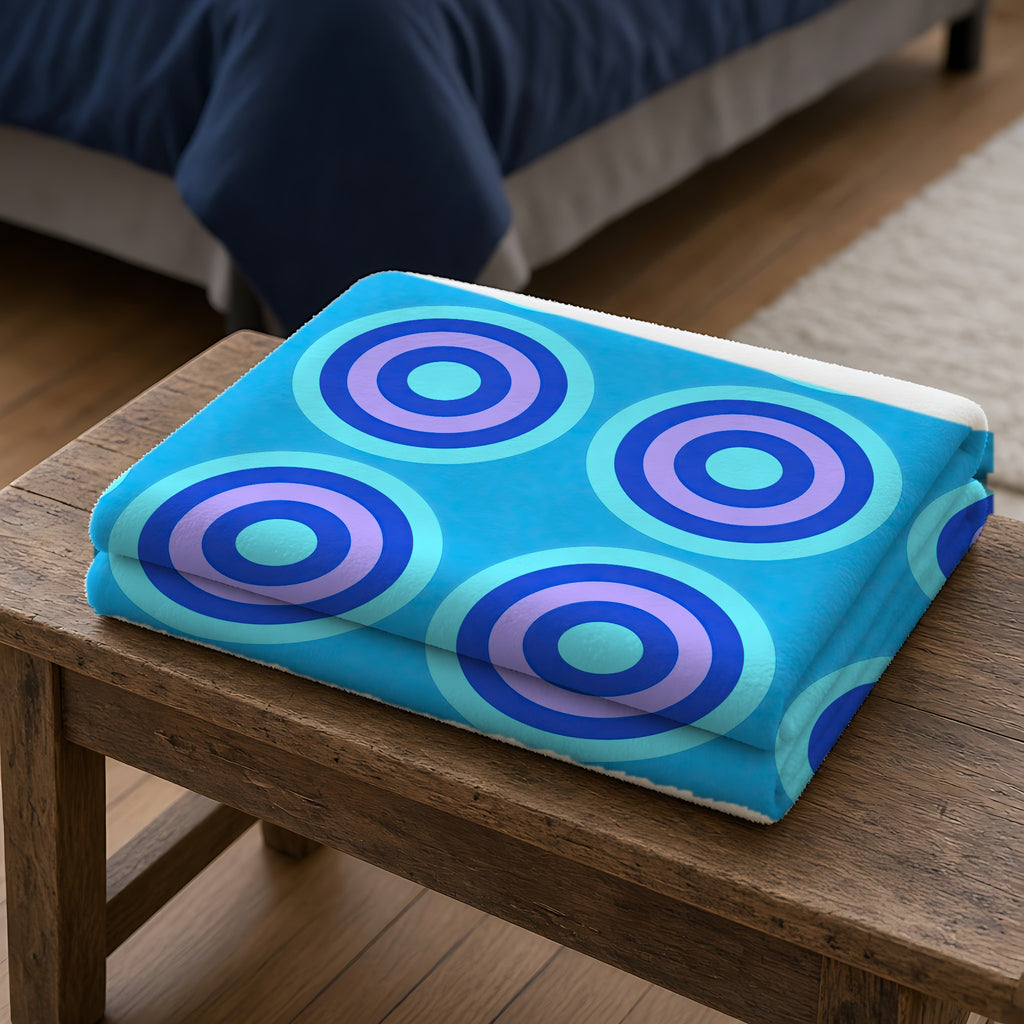 Mega Ring Grid Sherpa Fleece Blanket folded on a wooden bench
