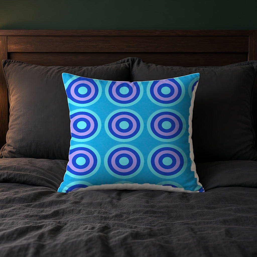 Mega Ring Grid Faux Suede Cushion on a bed with charcoal bedding