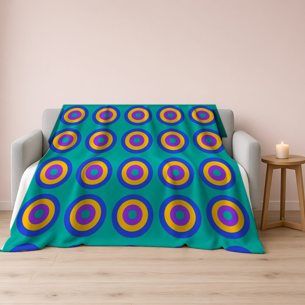 Giant Op-Art Jewel Rings Sherpa Fleece Blanket draped over a grey sofa