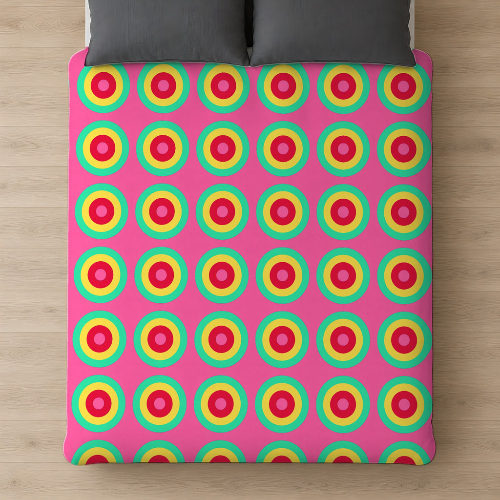 Giant Op-Art Jewel Rings Cotton Duvet Cover on a bed, seen from above