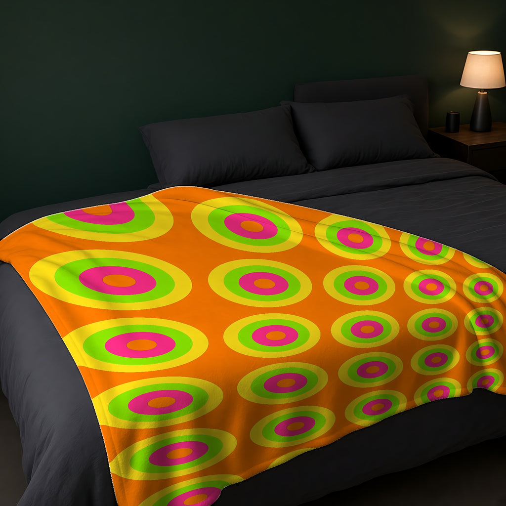 Giant Op-Art Jewel Rings Sherpa Fleece Blanket across the foot of a dark bed