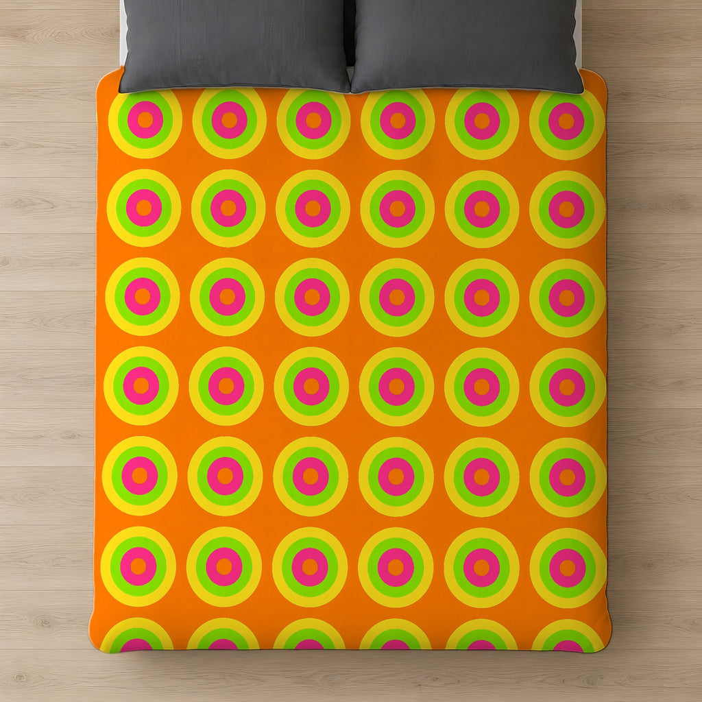 Giant Op-Art Jewel Rings Comforter on a bed, seen from above