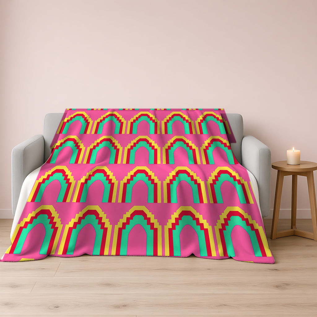 Grand Stepped Arches Sherpa Fleece Blanket draped over a grey sofa