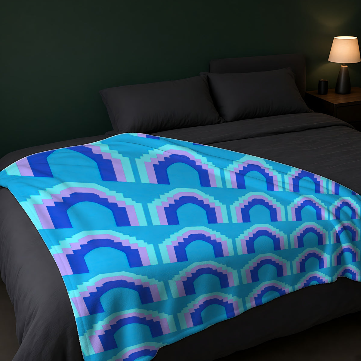 Grand Stepped Arches Sherpa Fleece Blanket across the foot of a dark bed