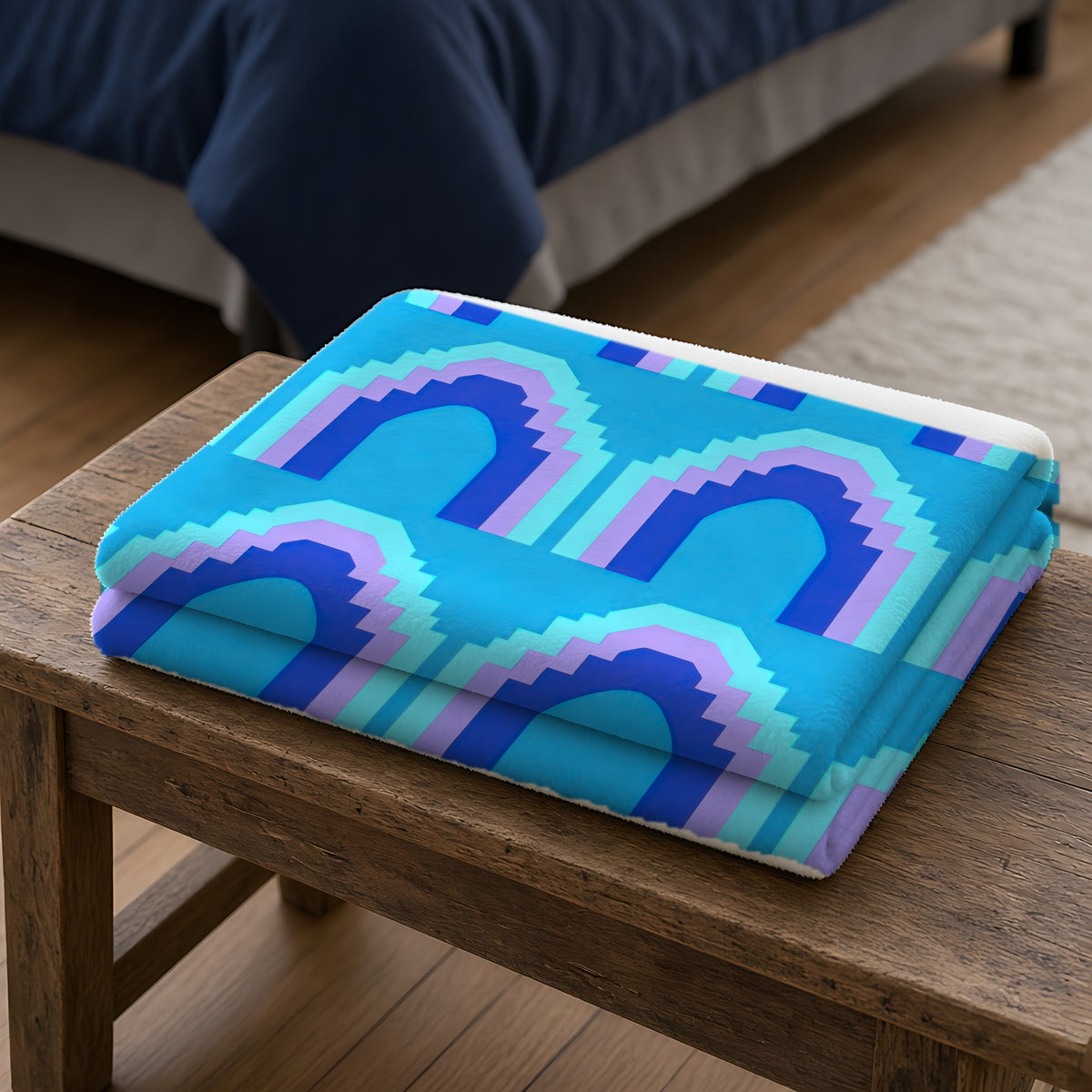 Grand Stepped Arches Sherpa Fleece Blanket folded on a wooden bench
