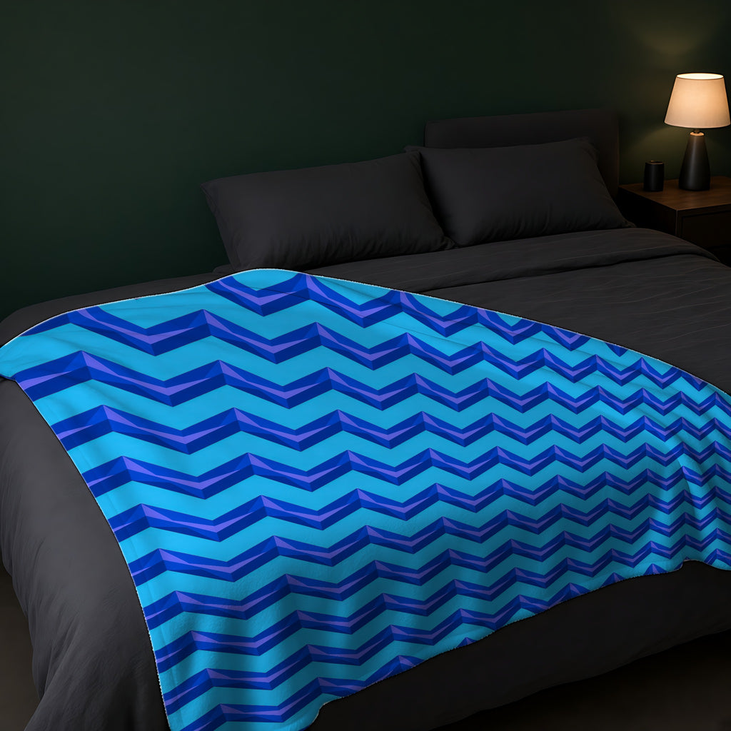 Broad Cut-Gem Chevrons Sherpa Fleece Blanket across the foot of a dark bed