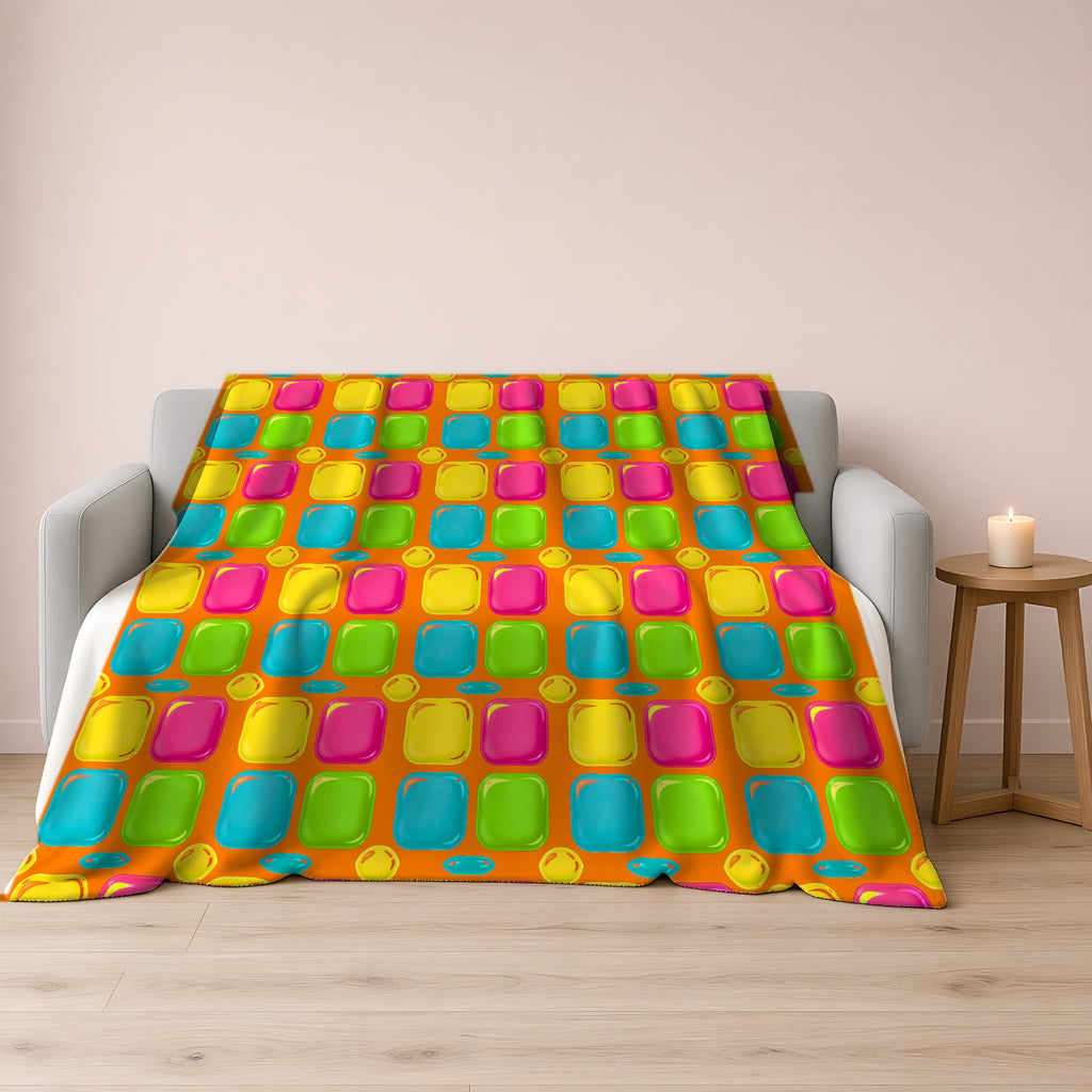 Giant Puffy Glass Cushions Sherpa Fleece Blanket draped over a grey sofa