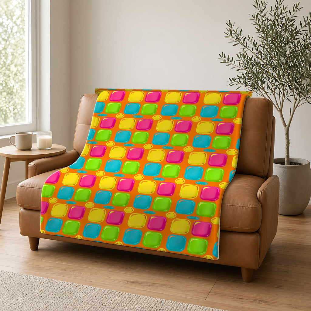 Giant Puffy Glass Cushions Sherpa Fleece Blanket draped over a caramel leather sofa
