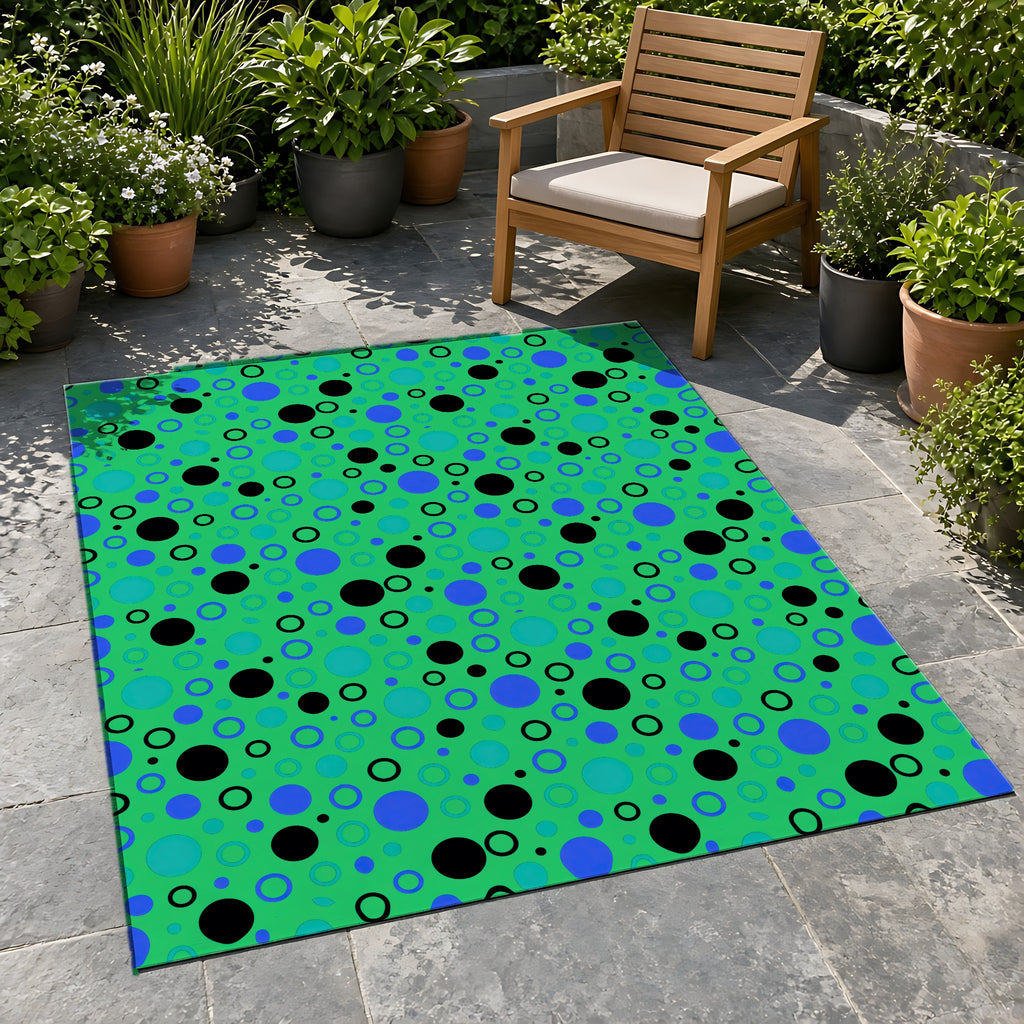 Bubble Outlines Outdoor Rug on a stone patio with potted plants