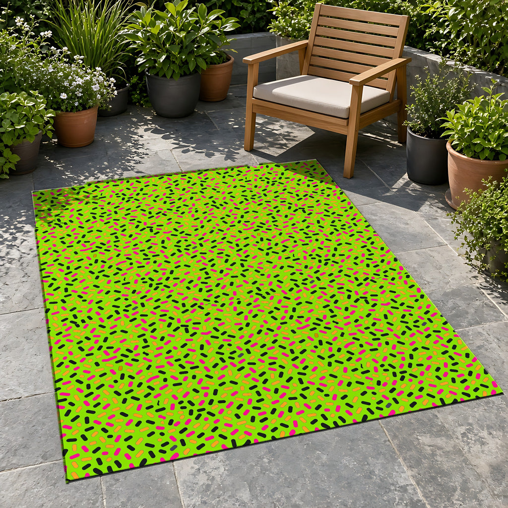 Sprinkle Pop Outdoor Rug on a stone patio with potted plants
