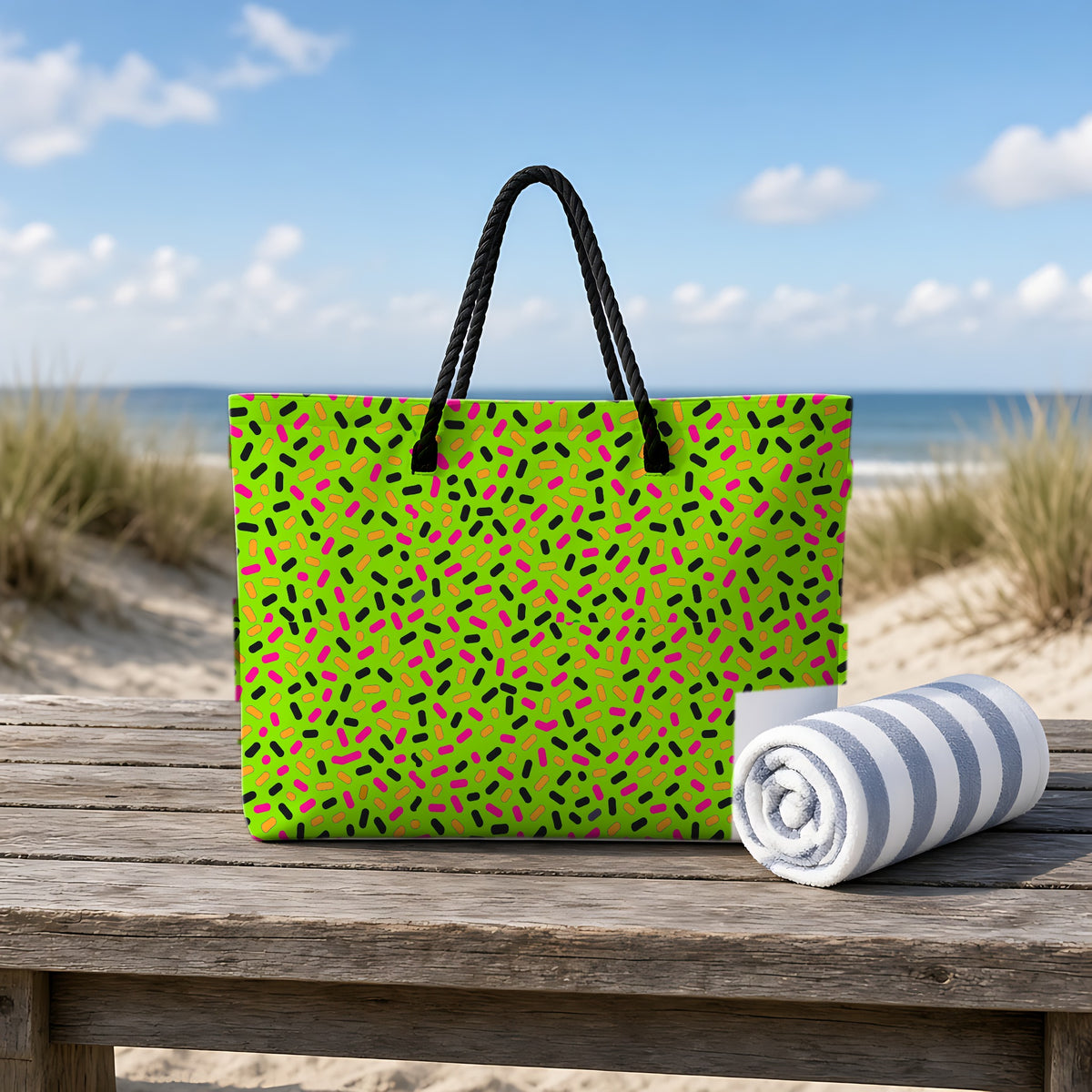 Sprinkle Pop Weekender Tote Bag on a rustic table by the beach