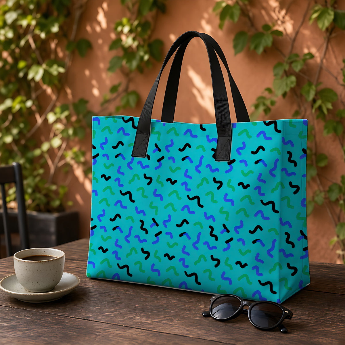 Squiggle Strokes Weekender Tote Bag on a garden café table