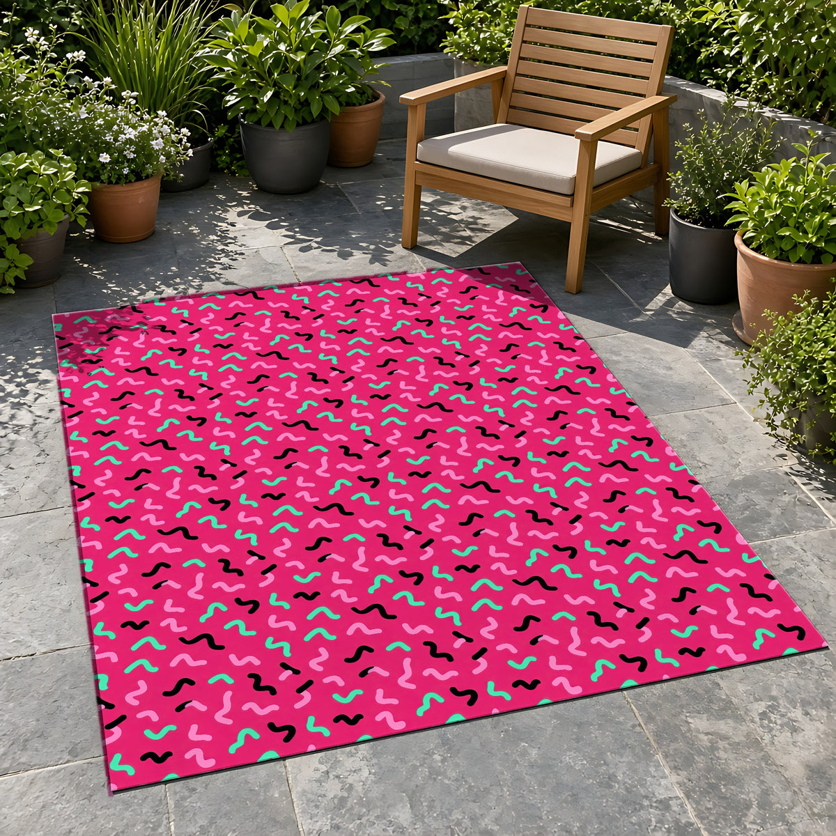 Squiggle Strokes Outdoor Rug on a stone patio with potted plants