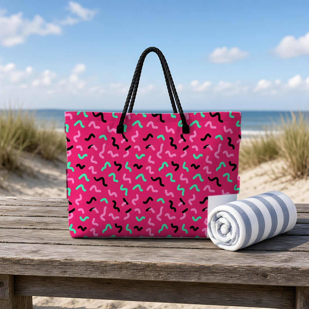 Squiggle Strokes Weekender Tote Bag on a rustic table by the beach