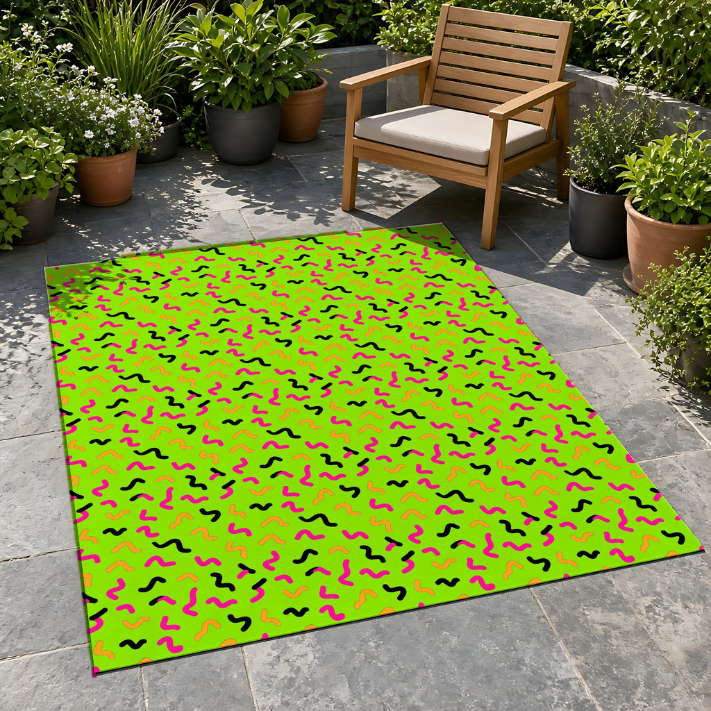 Squiggle Strokes Outdoor Rug on a stone patio with potted plants