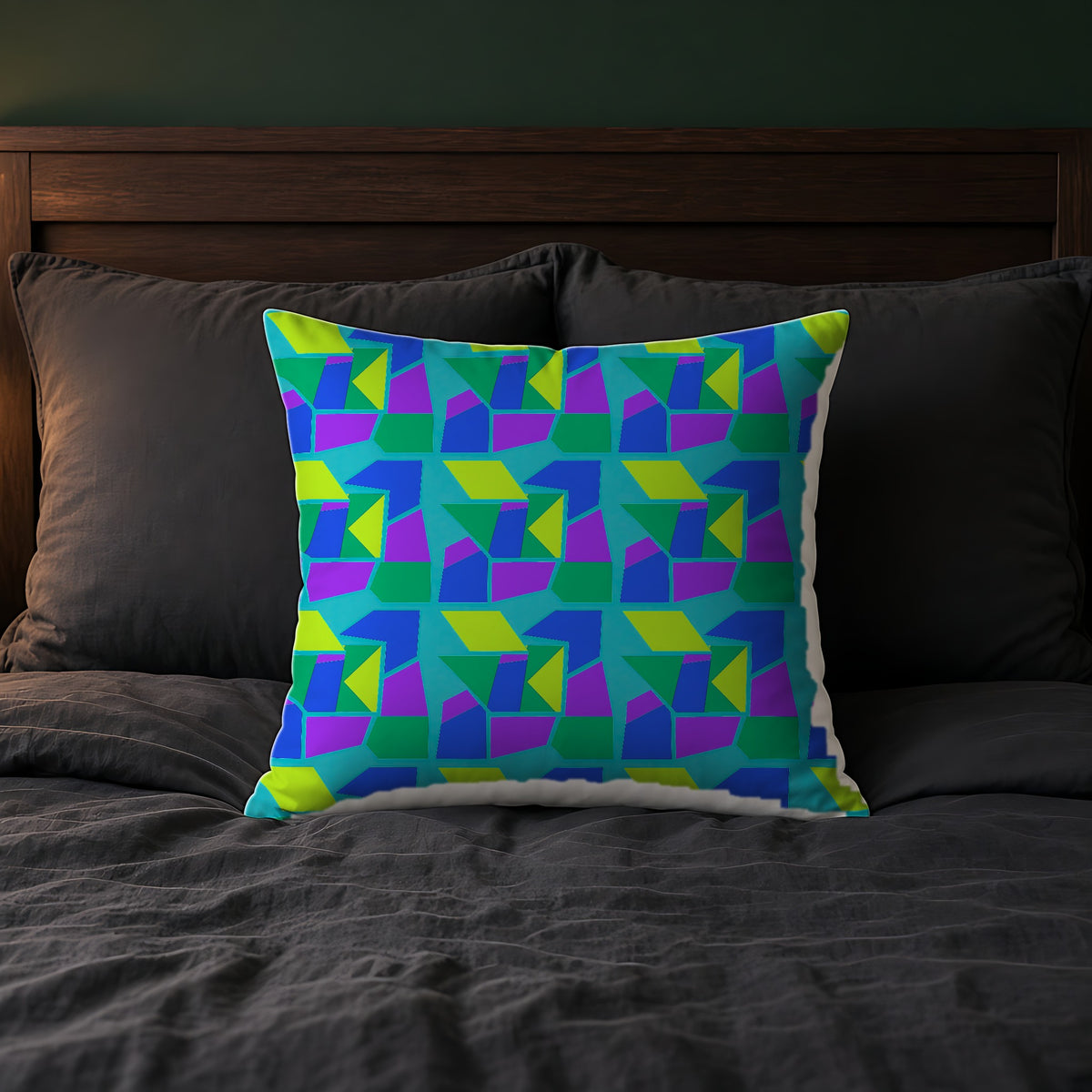 Cubist Block Quilt Faux Suede Cushion on a bed with charcoal bedding