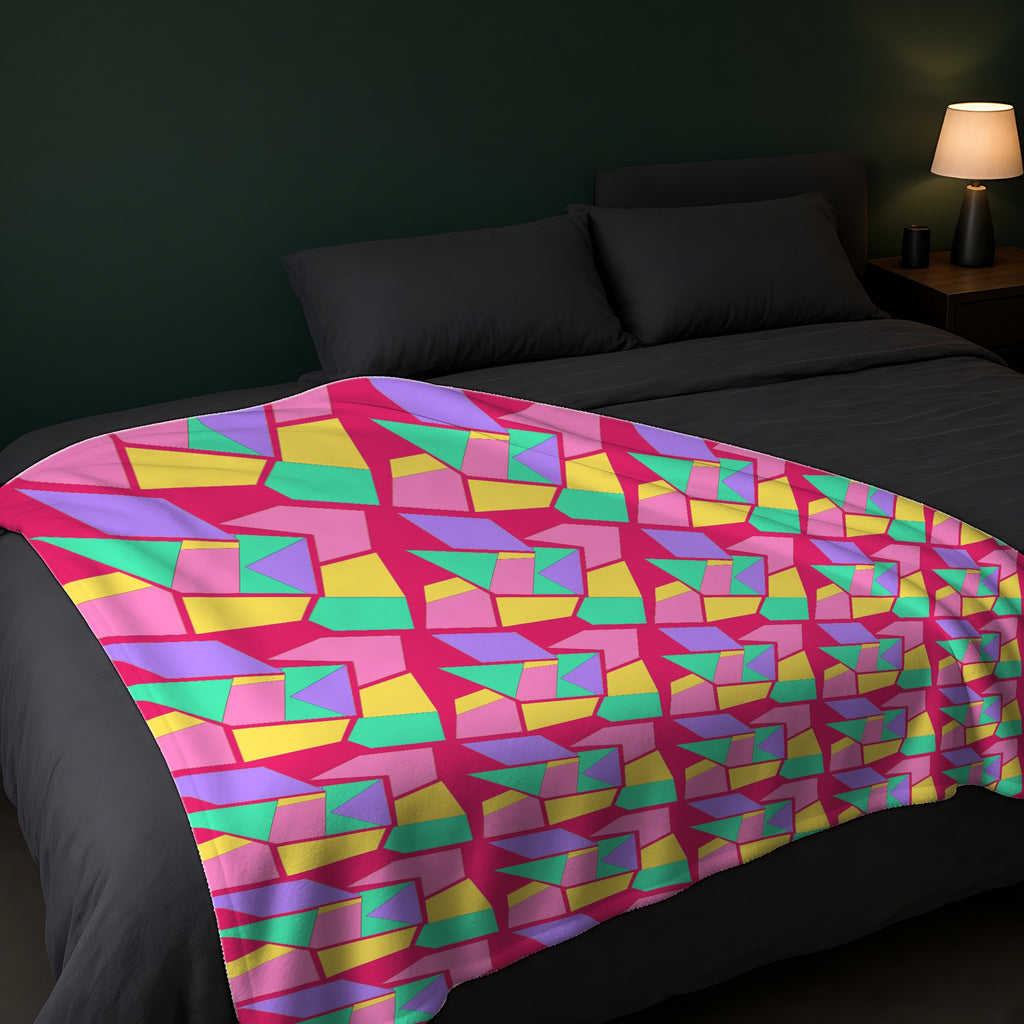 Cubist Block Quilt Sherpa Fleece Blanket across the foot of a dark bed