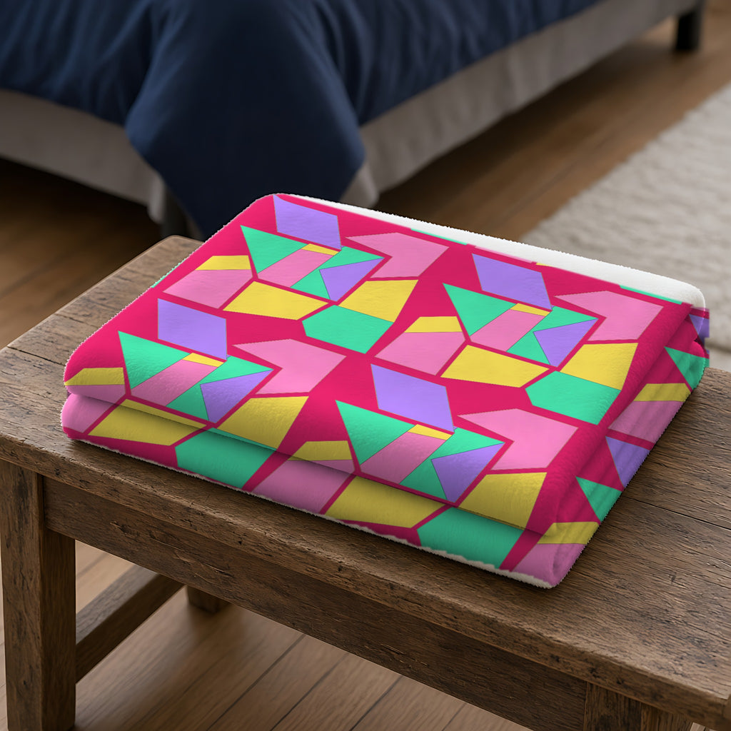 Cubist Block Quilt Sherpa Fleece Blanket folded on a wooden bench