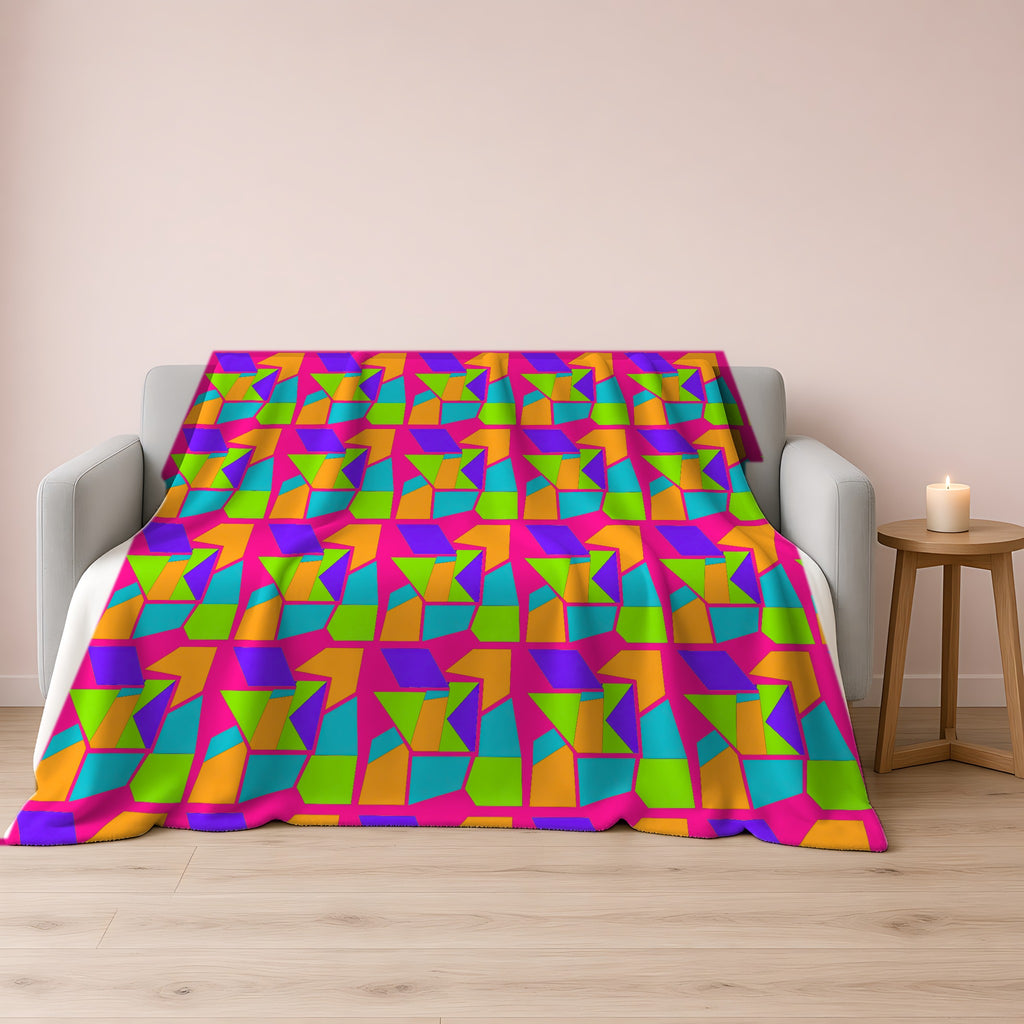 Cubist Block Quilt Sherpa Fleece Blanket draped over a grey sofa