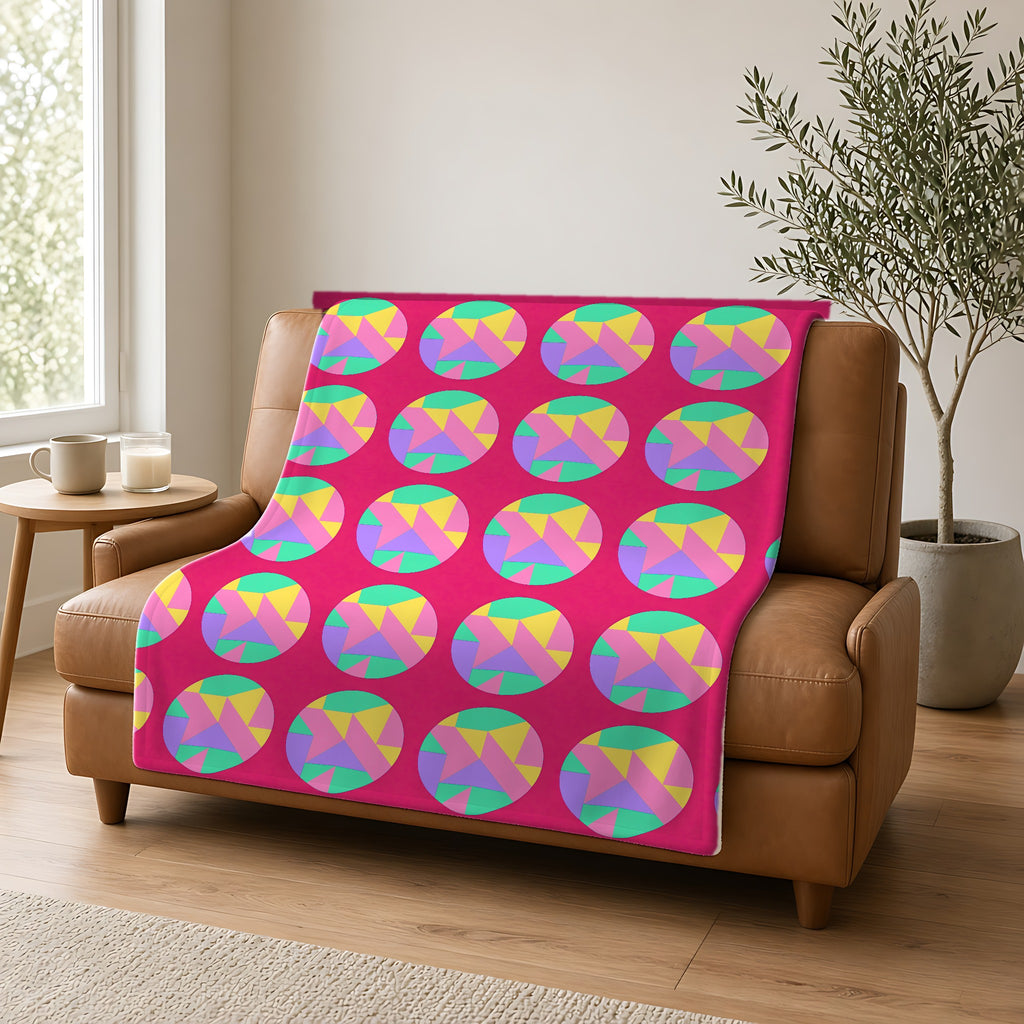 Broken Circle Planes Sherpa Fleece Blanket draped over a caramel leather sofa