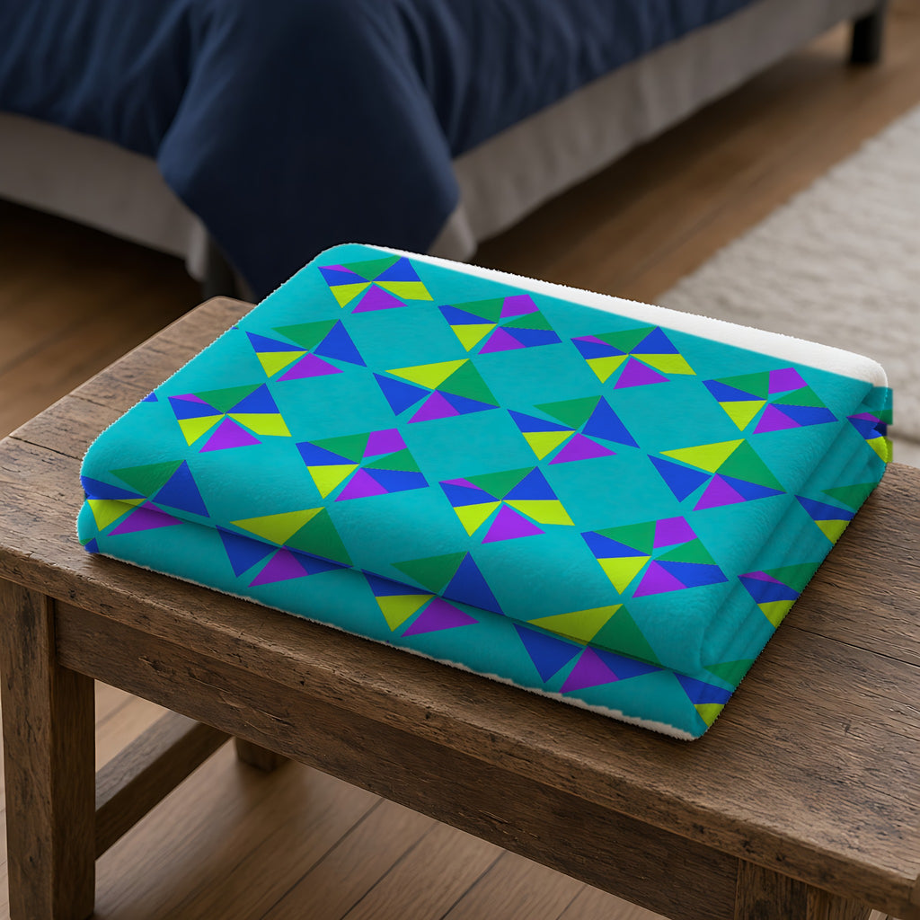 Stacked Cubist Prisms Sherpa Fleece Blanket folded on a wooden bench