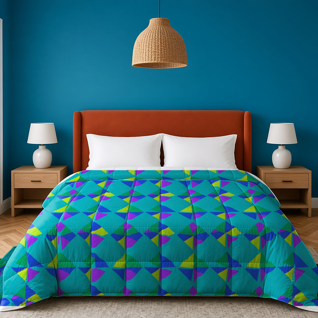 Stacked Cubist Prisms Comforter in the Peacock Jewel palette, on a bed with a rust headboard against a teal wall