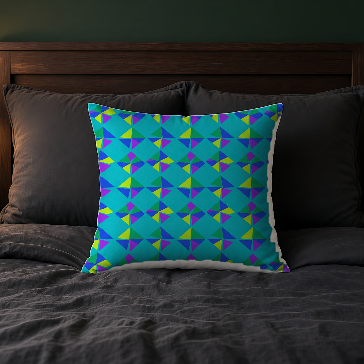 Stacked Cubist Prisms Faux Suede Cushion on a bed with charcoal bedding
