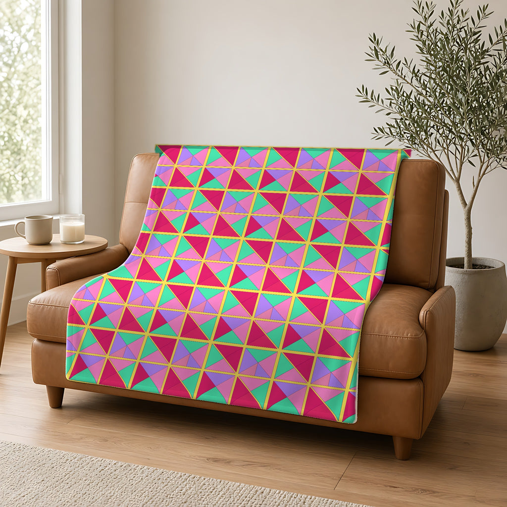 Split Square Fiesta Sherpa Fleece Blanket draped over a caramel leather sofa