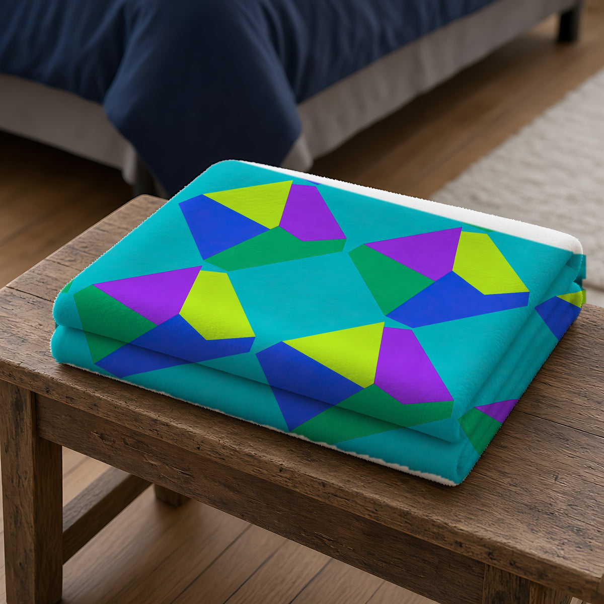 Grand Fractured Rhombus Sherpa Fleece Blanket folded on a wooden bench