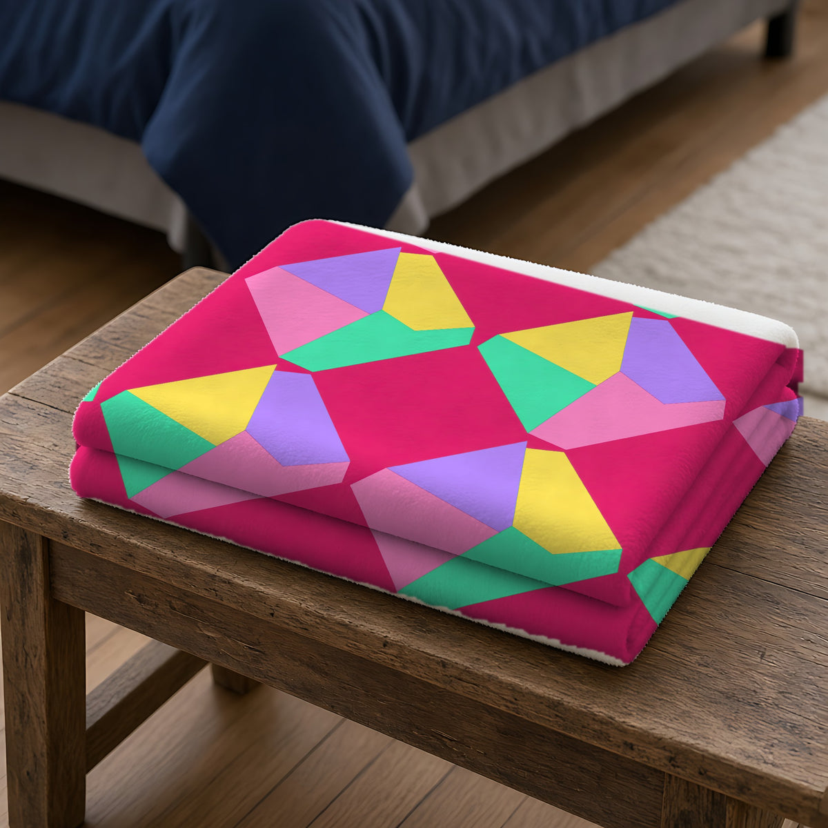 Grand Fractured Rhombus Sherpa Fleece Blanket folded on a wooden bench