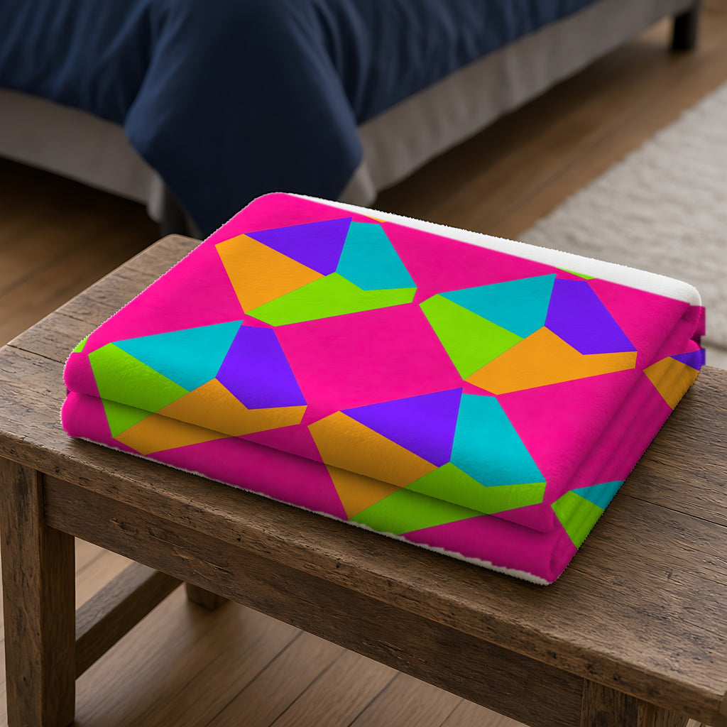 Grand Fractured Rhombus Sherpa Fleece Blanket folded on a wooden bench