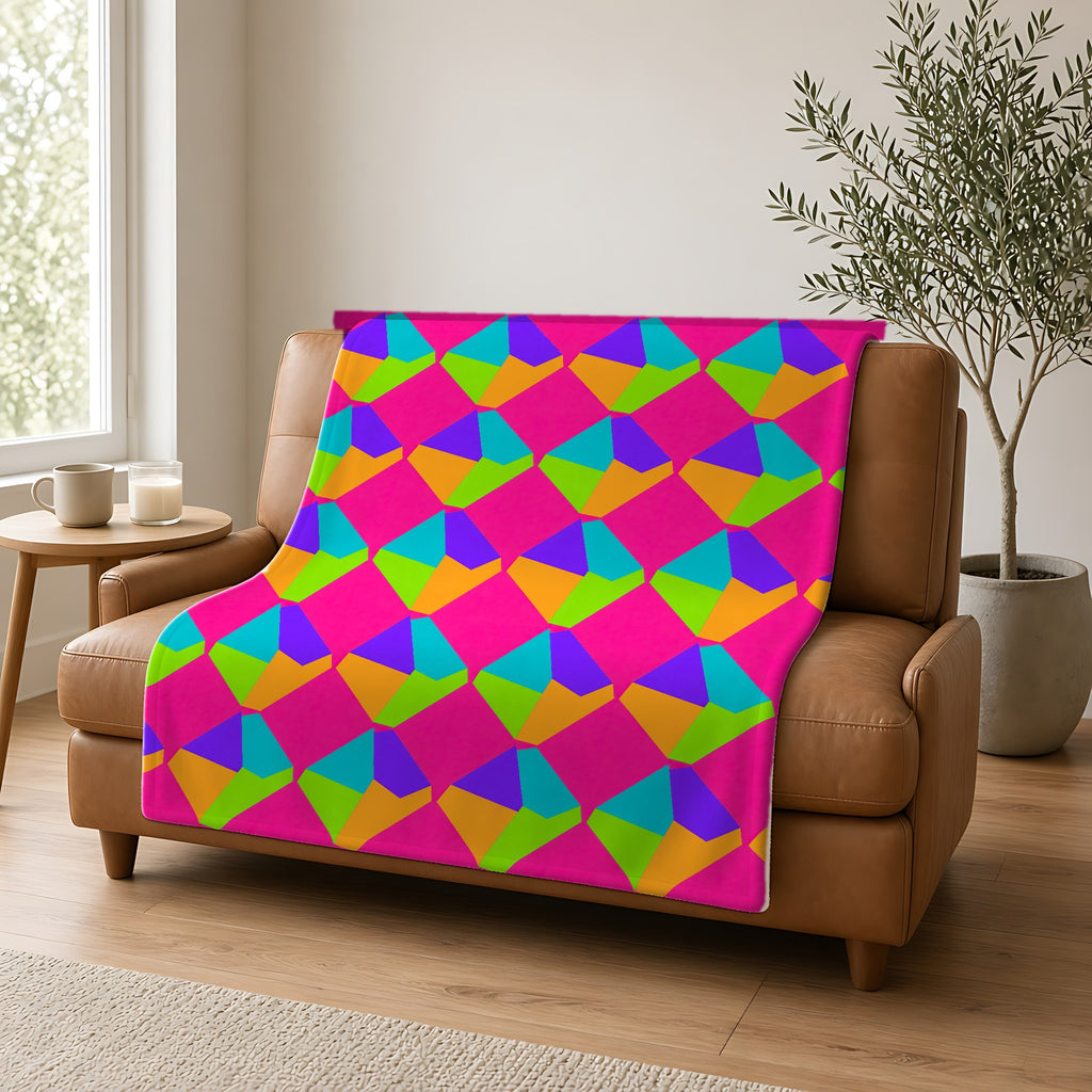 Grand Fractured Rhombus Sherpa Fleece Blanket draped over a caramel leather sofa