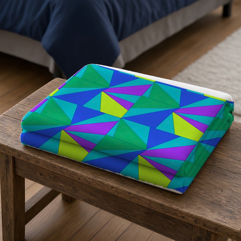 Cubist Sunburst Blocks Sherpa Fleece Blanket folded on a wooden bench