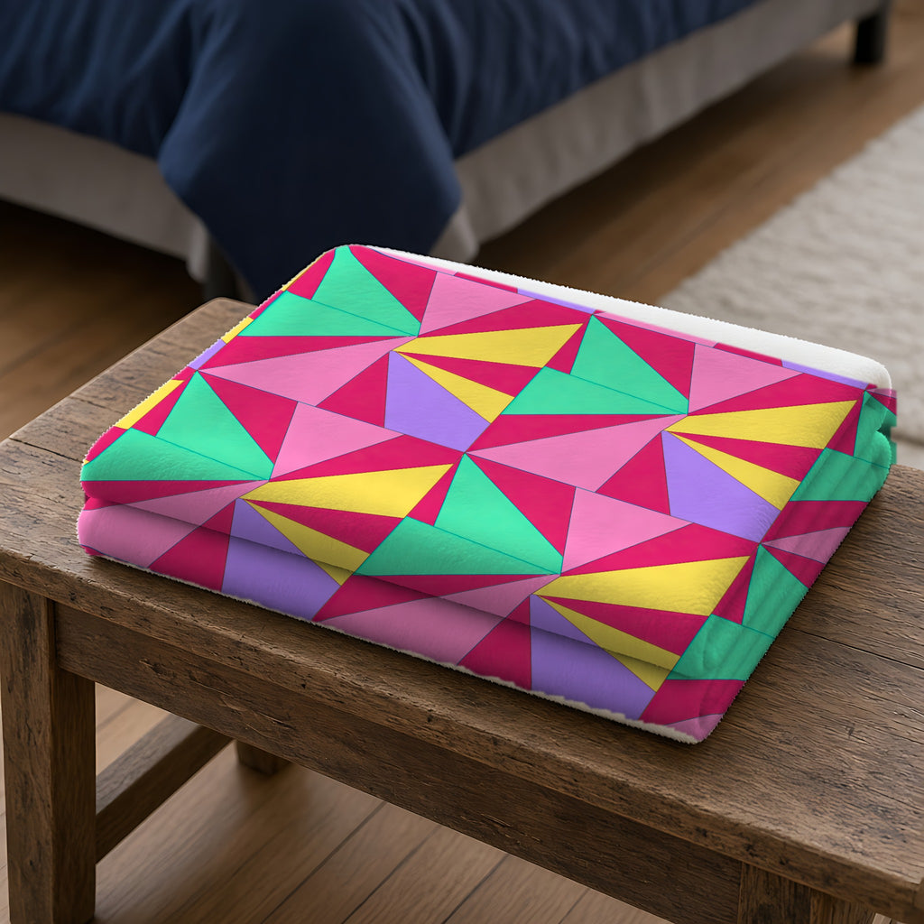 Cubist Sunburst Blocks Sherpa Fleece Blanket folded on a wooden bench