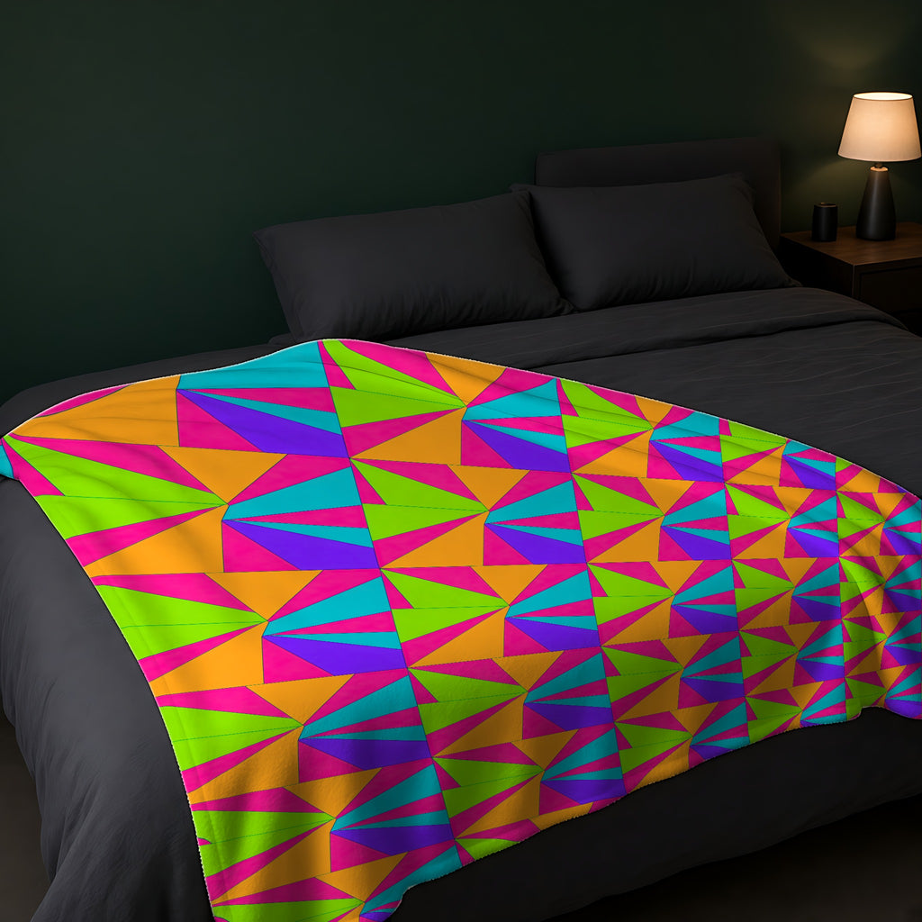 Cubist Sunburst Blocks Sherpa Fleece Blanket across the foot of a dark bed