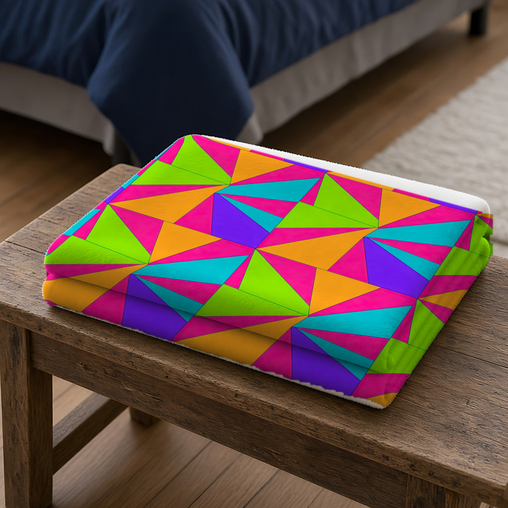 Cubist Sunburst Blocks Sherpa Fleece Blanket folded on a wooden bench