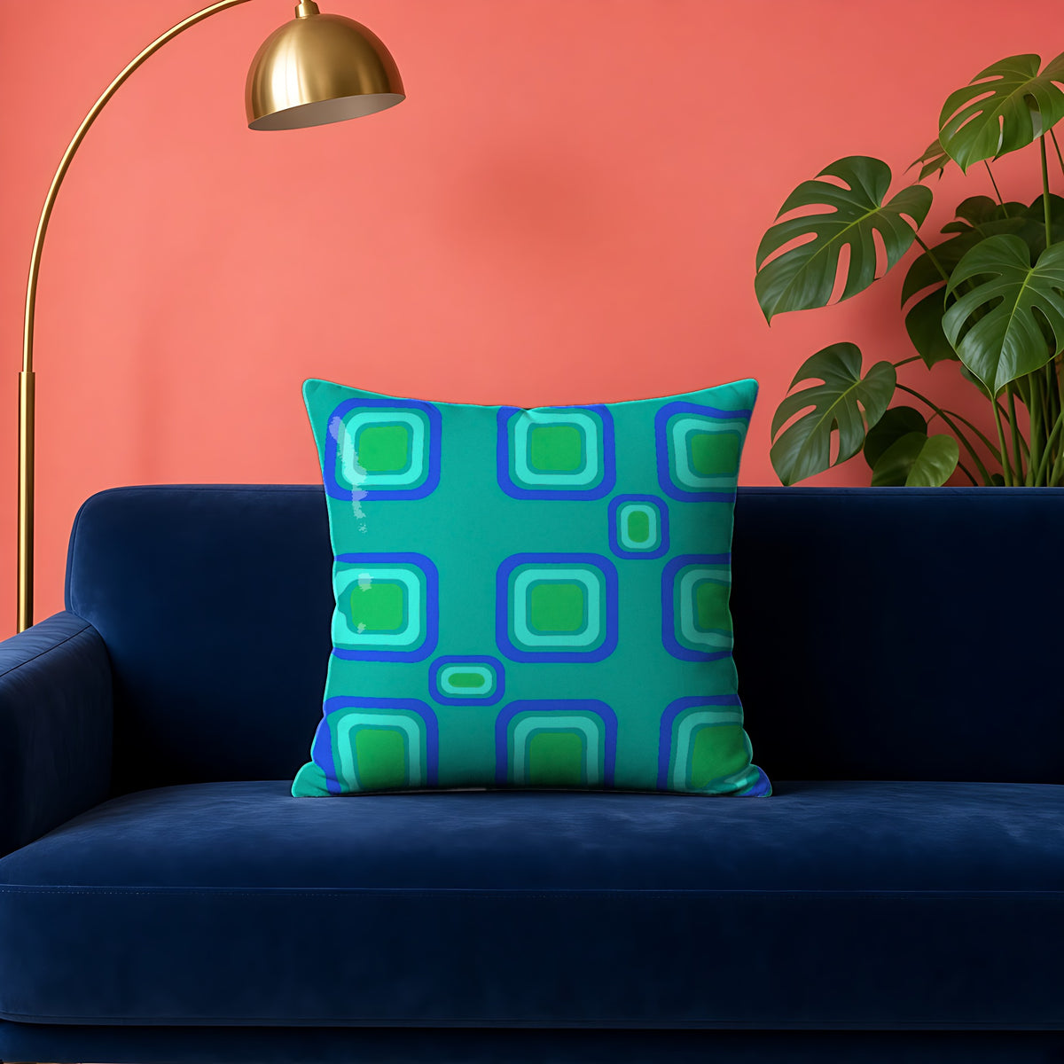 Big Ripple Squares Faux Suede Cushion in the Ocean Jewel palette, on a navy velvet sofa against a coral wall