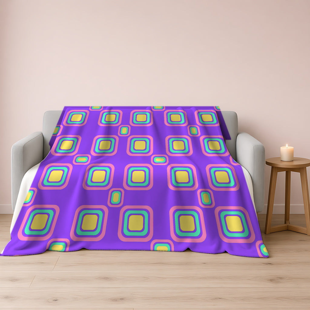 Big Ripple Squares Sherpa Fleece Blanket draped over a grey sofa