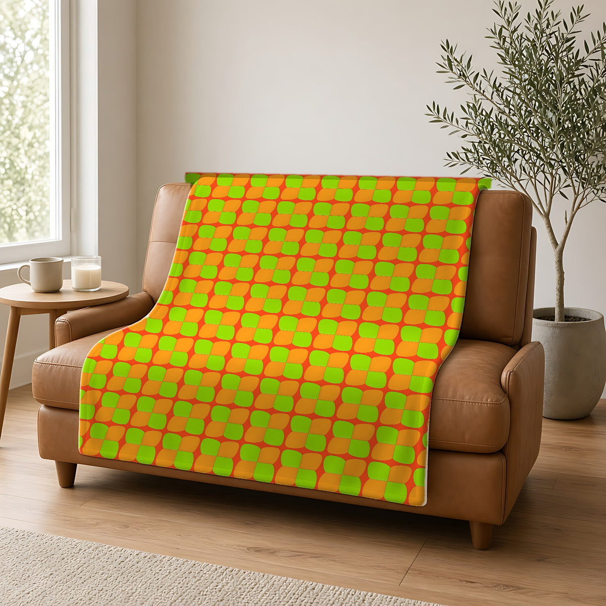 Bold Bulge Checker Sherpa Fleece Blanket draped over a caramel leather sofa