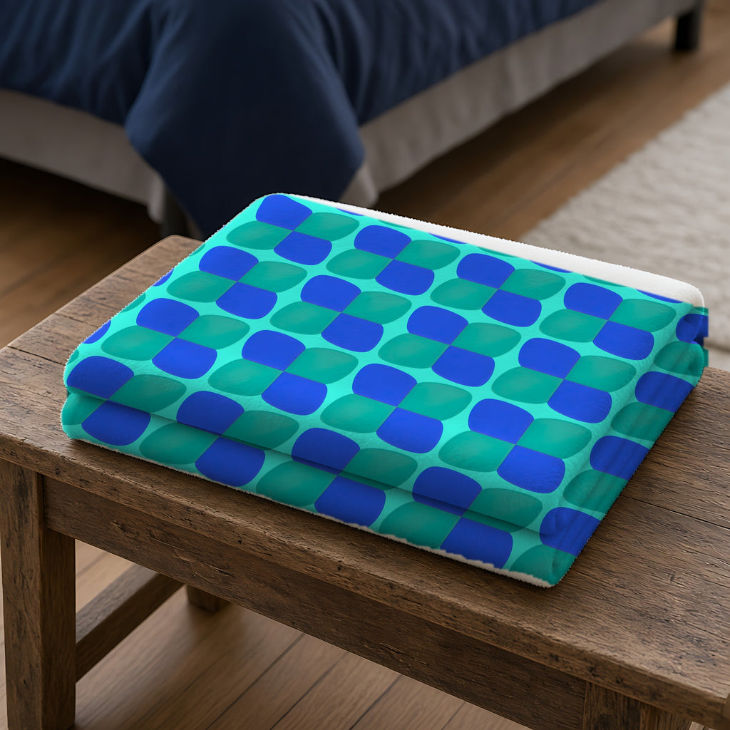 Bold Bulge Checker Sherpa Fleece Blanket folded on a wooden bench