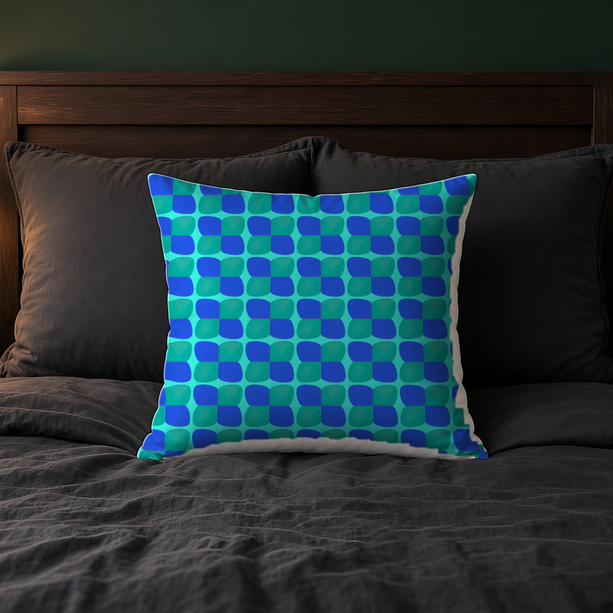 Bold Bulge Checker Faux Suede Cushion on a bed with charcoal bedding