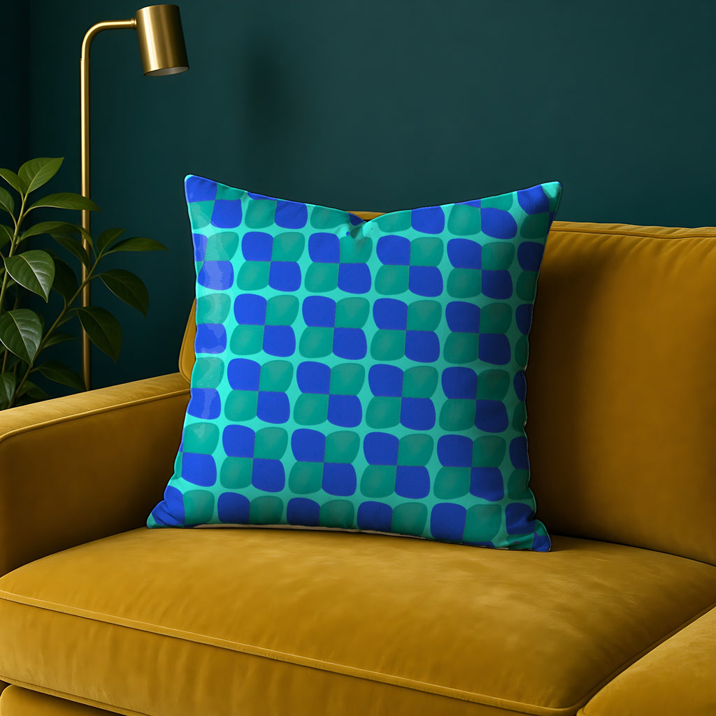 Bold Bulge Checker Faux Suede Cushion in the Ocean Jewel palette, on a mustard sofa against a teal wall
