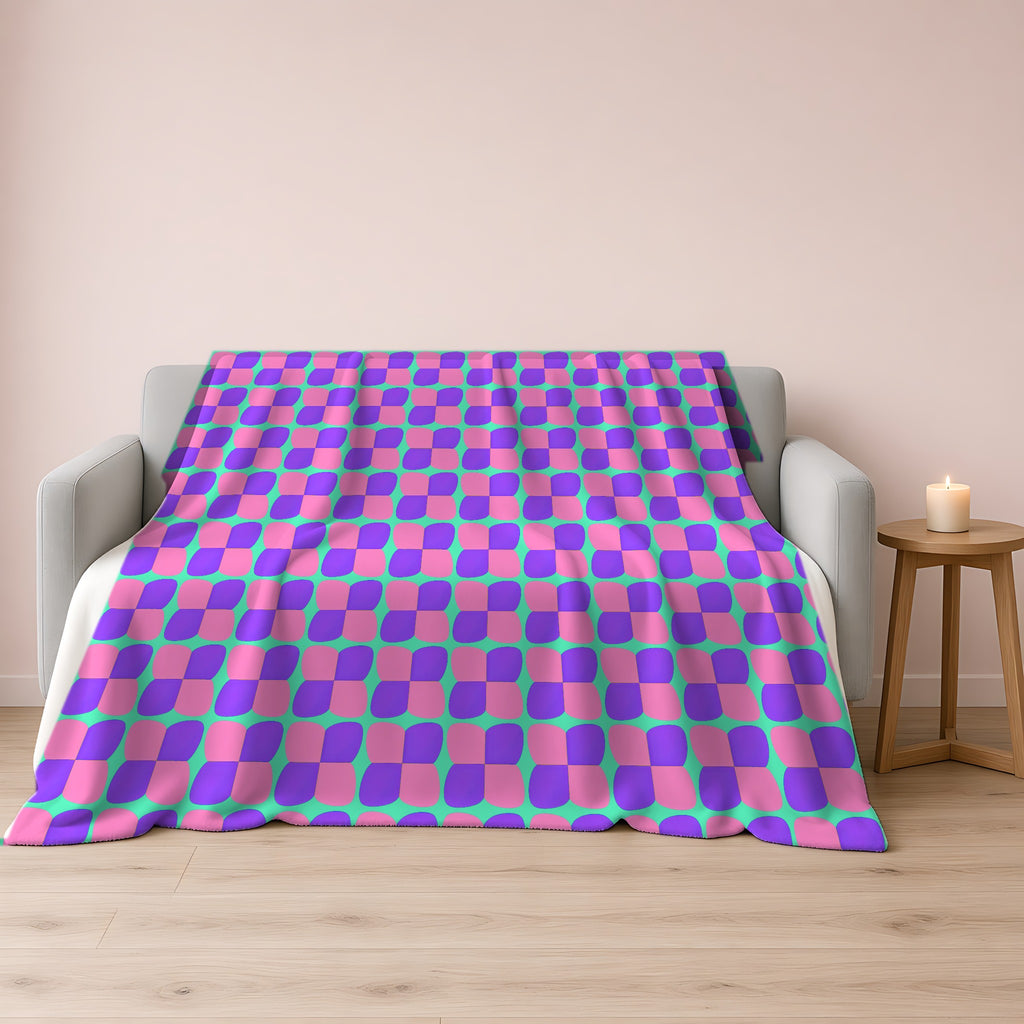 Bold Bulge Checker Sherpa Fleece Blanket draped over a grey sofa