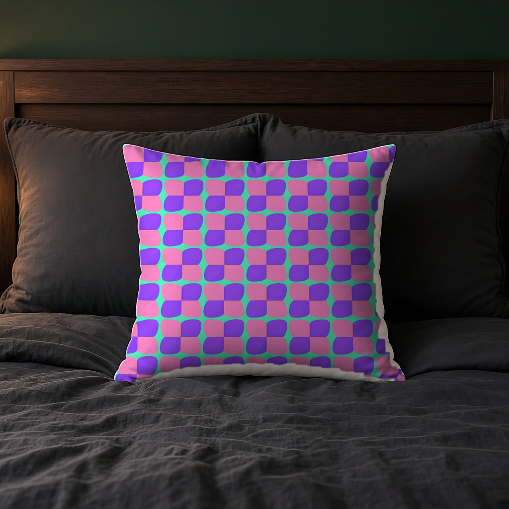 Bold Bulge Checker Faux Suede Cushion on a bed with charcoal bedding